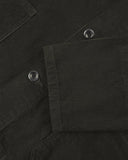 Closer view of mid section of green-brown (seaweed), buttoned corduroy overshirt from Uskees. Focus on cuff, pockets, corozo buttons and corduroy texture.