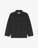 Front flat shot of charcoal-grey, buttoned corduroy overshirt. Clear view of chest and hip pockets, corozo buttons and Uskees branding label.
