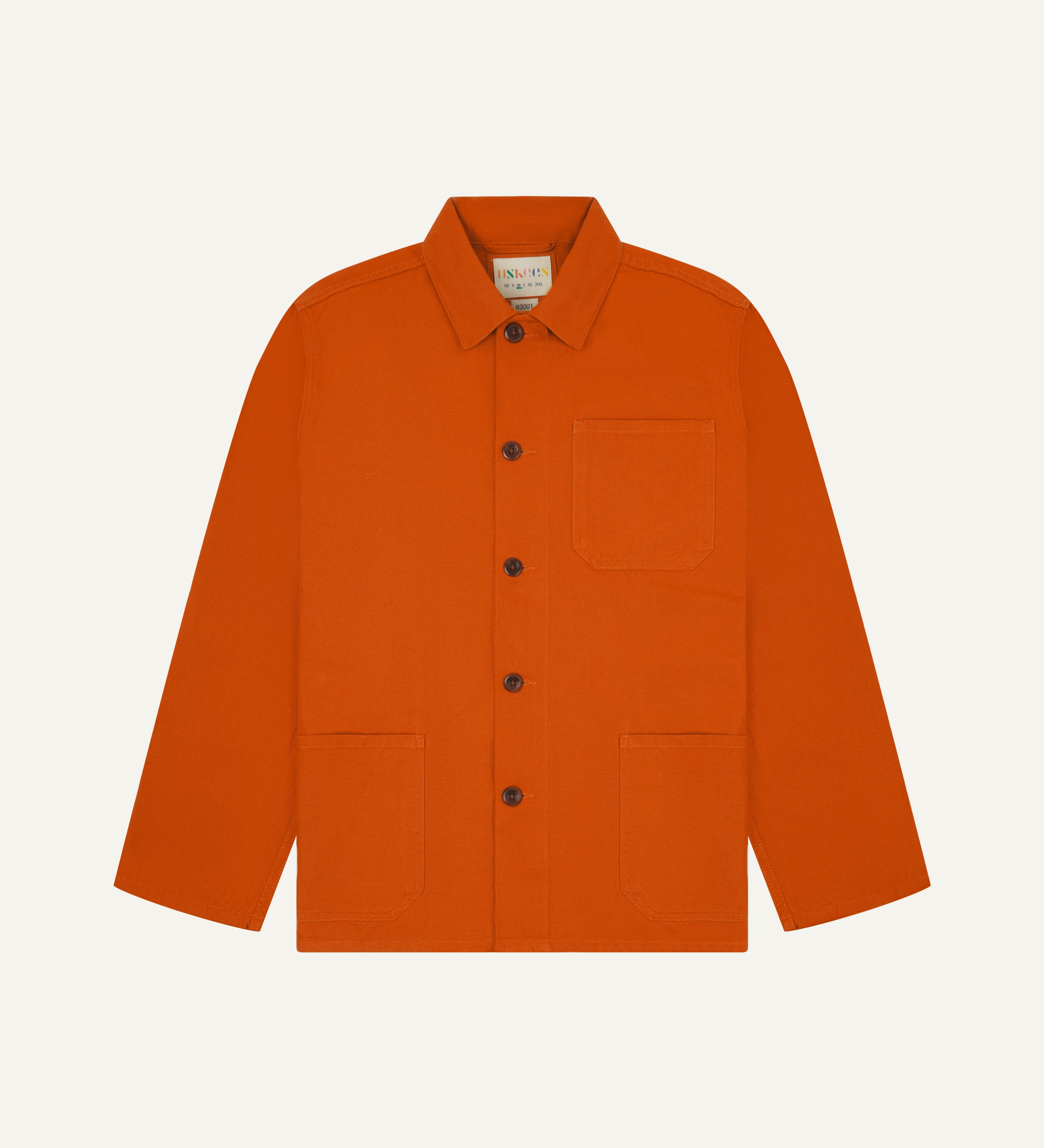 Front flat shot of an uskees orange men's overshirt showing contrast brown corozo buttons and brand label at neck.