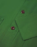 Closer view of mid section of mint green, buttoned organic cotton overshirt from Uskees. Focus on cuff, placket and corozo buttons.
