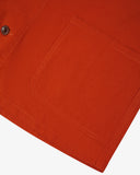 Close-up of a rust-orange pocket on an uskees 3001 overshirt with a white background