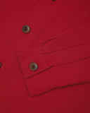 View of the mid-section and sleeve of the 3003 Uskees button-down work shirt in berry red with focus on cuff, placket and corozo buttons.