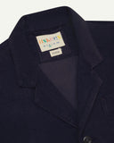 Close-up front view of organic cord midnight blue blazer showing the collar, lapels and Uskees brand label.