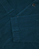 Close-up view of cuff, placket and corozo buttons of organic corduroy, petrol blue blazer from Uskees.
