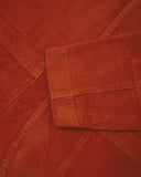 Close-up view of cuff, placket and corozo buttons of rust-red blazer from Uskees and providing a clearer view of the 11 wale organic corduroy.
