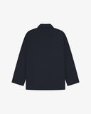 Reverse of dark blue (blueberry) buttoned organic cotton-drill blazer from Uskees showing reinforced elbows and boxy silhouette.