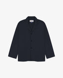 Dark blue (blueberry) buttoned organic cotton-drill blazer from Uskees with clear view of three patch pockets and Uskees branding label.