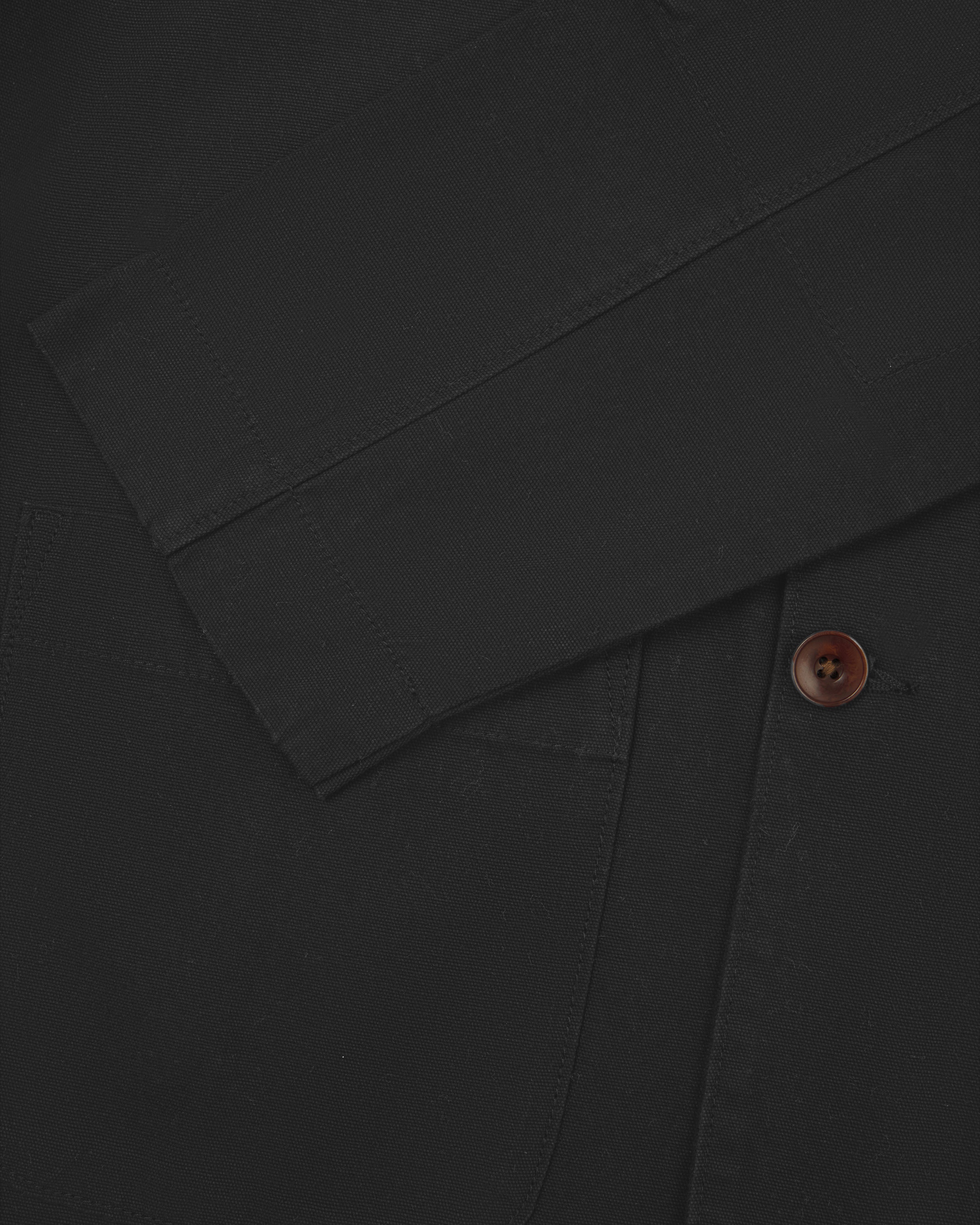 Close flat shot of dark grey organic cotton men's blazer from Uskees showing cuff and corozo button.