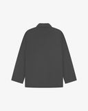 Reverse of charcoal-grey buttoned organic cotton-drill blazer from Uskees showing reinforced elbows and boxy silhouette.