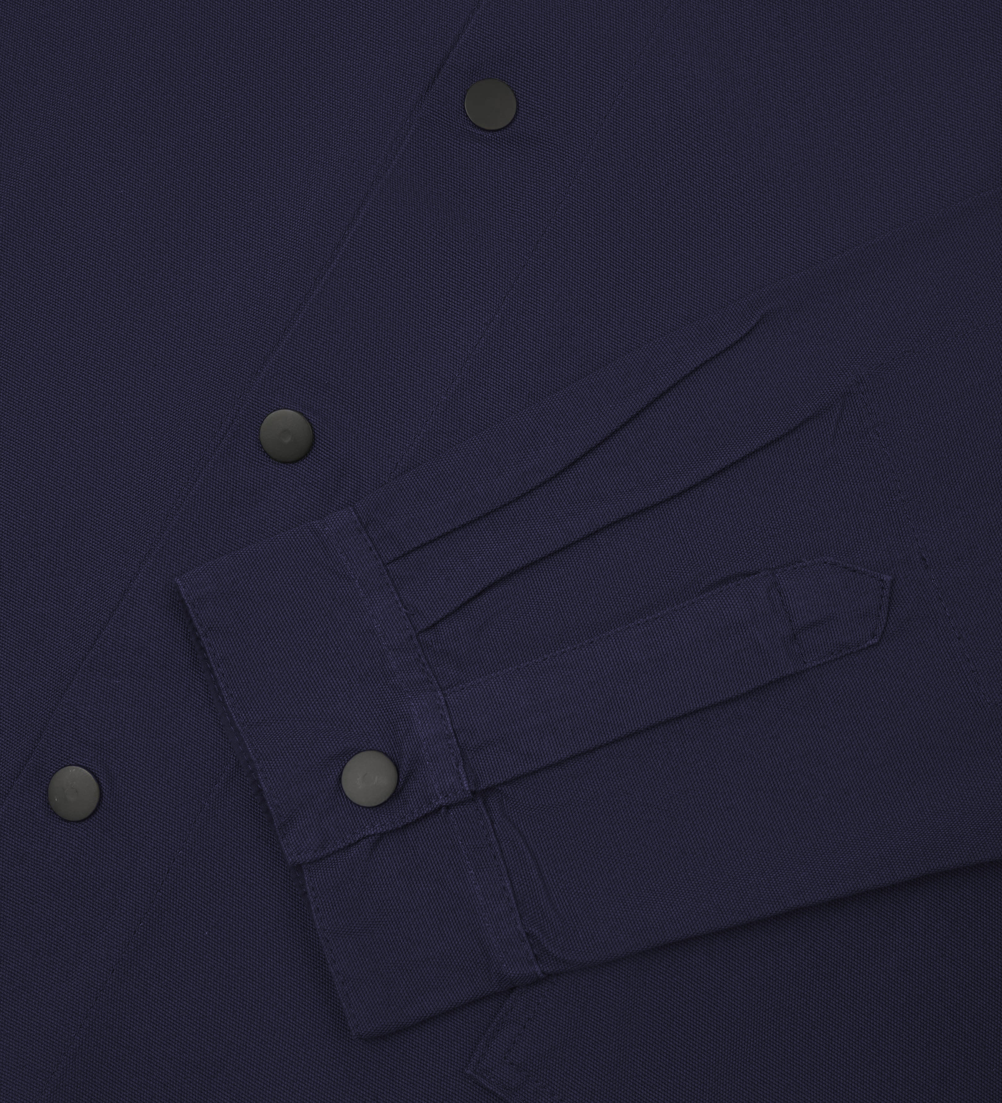  Close up shot of cuff and front popper fastening of Uskees #3013 coach jacket in midnight blue.