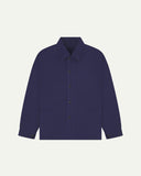 Flat front view of organic cotton deep indigo signal jacket from Uskees. Clearly showing the corozo button fastening and 2 deep hip pockets.
