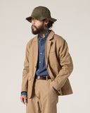 Uskees khaki docklands jacket worn by a bearded male model