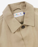 Beige men's car coat collar detail showing the Uskees brand label on a white background
