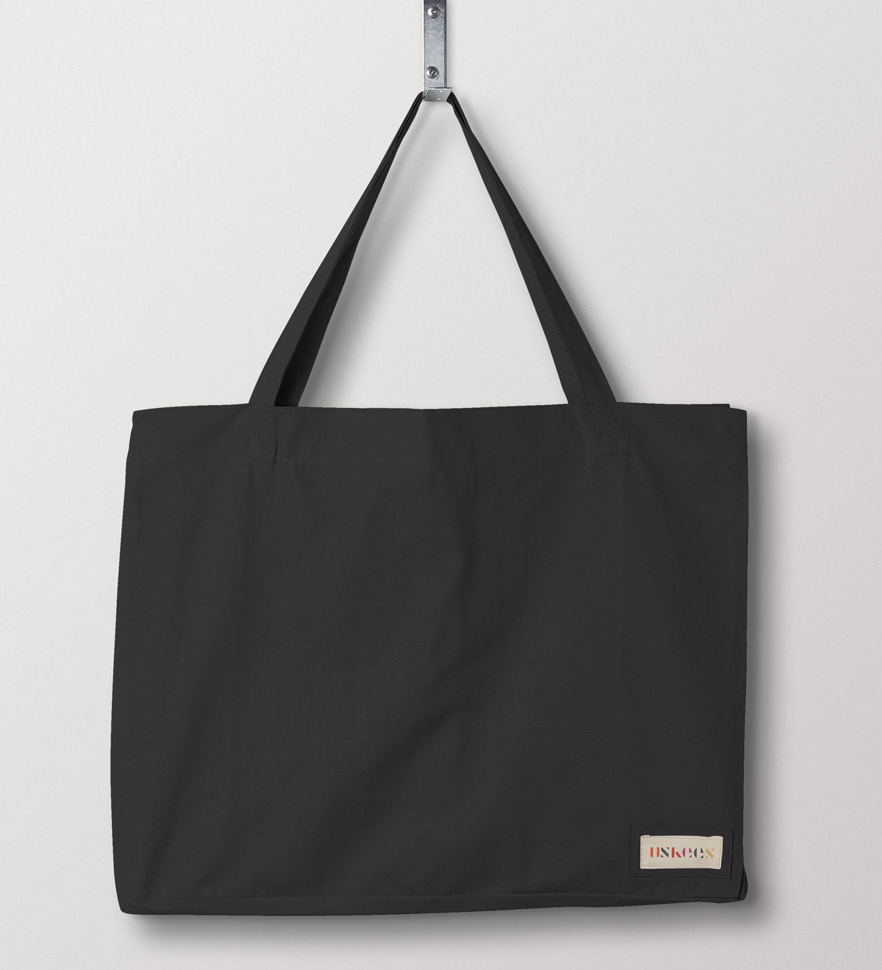Full front hanging shot of Uskees #4001 large charcoal tote bag, showing double handles and Uskees woven logo.