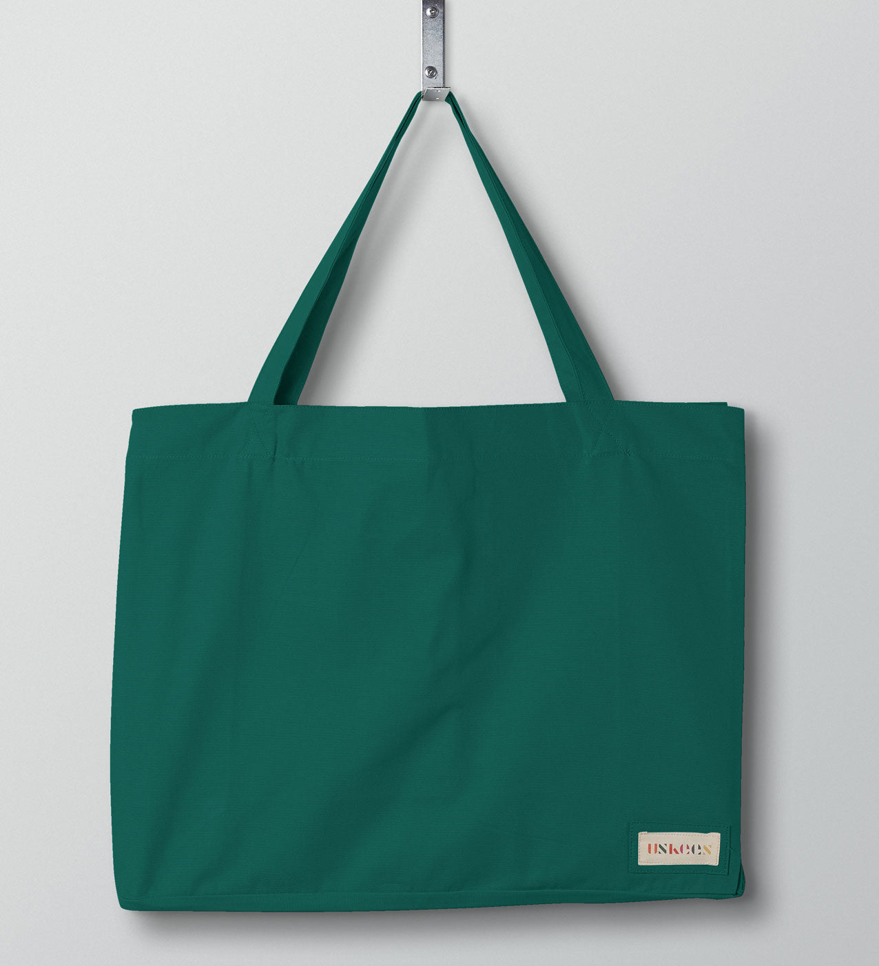 Full front hanging shot of Uskees #4001 large foam-green tote bag, showing double handles and Uskees woven logo.