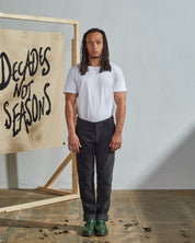 Full length front-view of model wearing faded-black corduroy 5005 trousers with view of YKK zip fly and Corozo buttons.