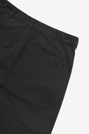 Close up back shot of Uskees 5005 twill workwear pants in black with focus on back pocket, adjustable waistband secured with Corozo button and belt loops.