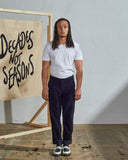 Full length front-view of model wearing midnight-blue corduroy 5005 trousers with view of YKK zip fly and Corozo buttons.