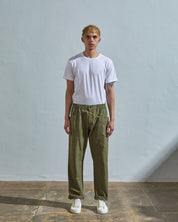 Full length front-view of model wearing olive light 160gsm cotton 5011 trousers with view of deep pockets and paired with plain white t-shirt.