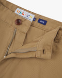 Close up view of 5016 Uskees men's organic twill khaki 'commuter' trousers showing the zip and button fly and brand label.