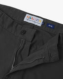 Close-up front view of the front zipper, belt loops and Corozo button fastening the of charcoal twill pants.