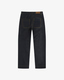 ull-length back view of raw orta denim workwear pants in dark indigo. Showing back pockets. On a white background.