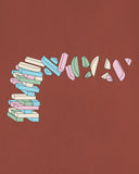 Close-up of Uskees men's graphic Tee showing the colourful geometric shapes on the chestnut brown t-shirt.