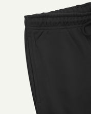 Front close-up view of dark grey organic cotton Jogging Pants for men by Uskees showing side pocket and drawstring waist detail.