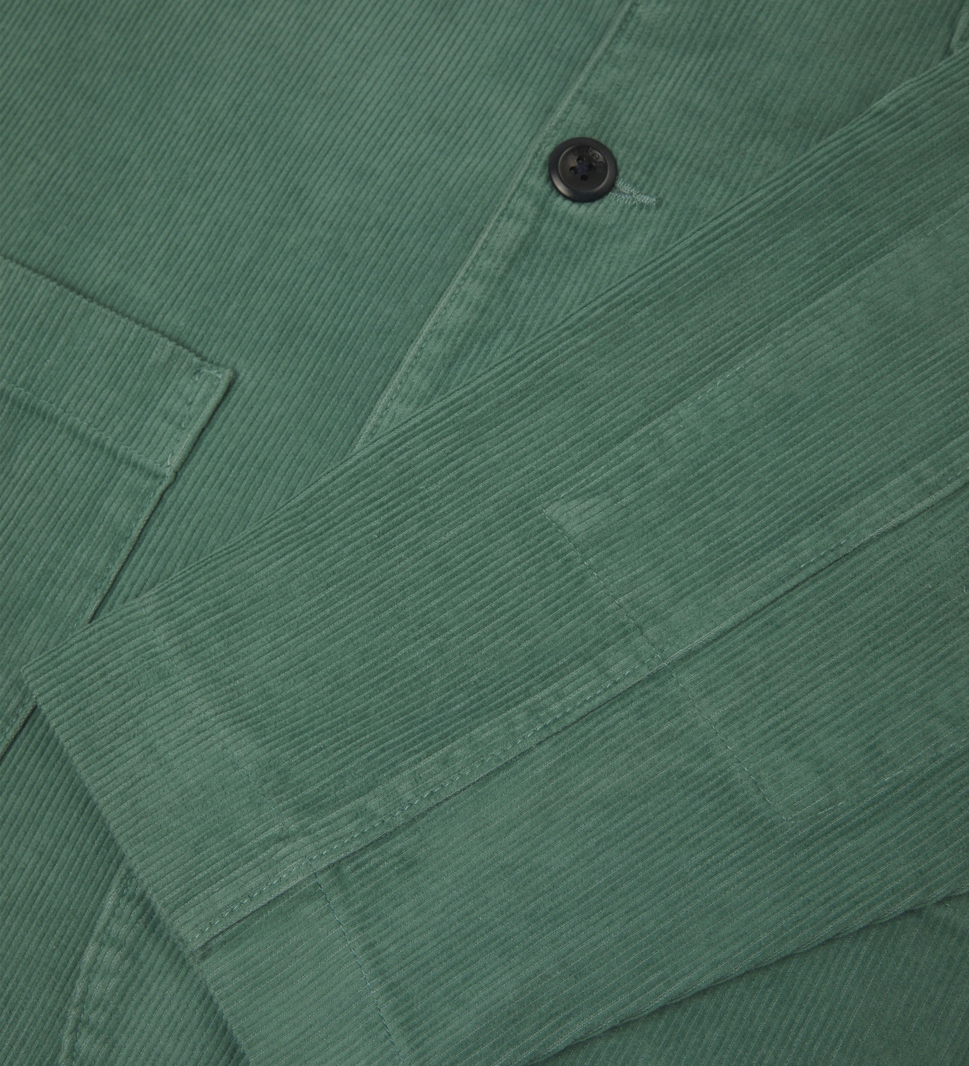 Front close view of eucalyptus-green corduroy blazer showing cuff detail.