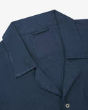 Close-up and angled front view of the 6004 Cuban utility shirt showing the texture of the breathable organic chambray cloth, collar, lapels and Uskees brand label.