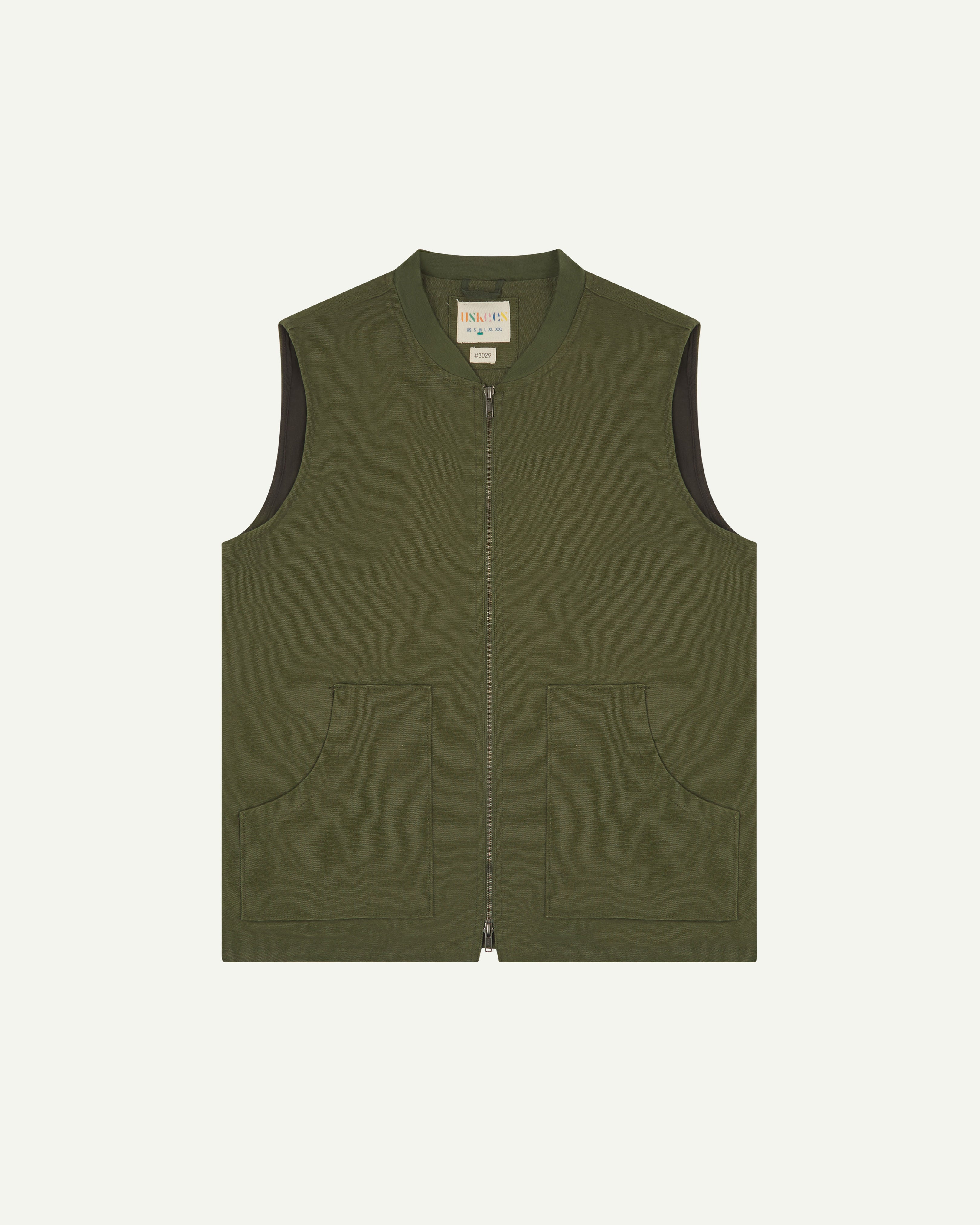 front flat shot of uskees green gilet-type zip front waistcoat showing the front pockets and inner brand label at neck