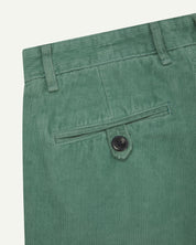 Back close-up shot of #5018 Uskees men's organic corduroy boat trousers in light green showing belt loops and buttoned back pocket.