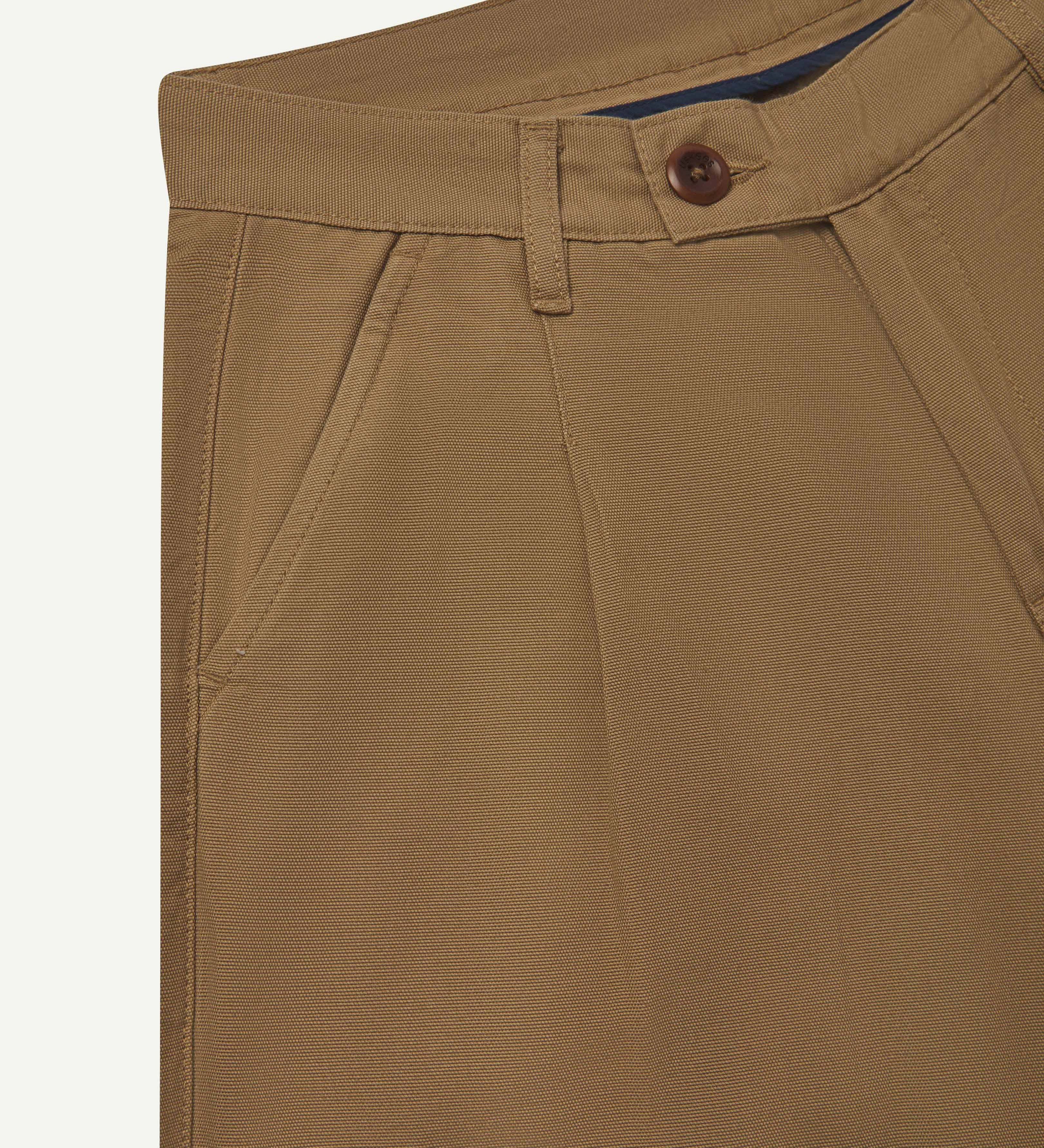 Close up front shot of #5018 Uskees men's organic cotton boat trousers in khaki showing waist band with belt loops and corozo button fastening.
