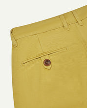 Back close-up view of #5018 Uskees men's organic mid-weight cotton boat trousers in acid yellow showing belt loops and buttoned back pocket.