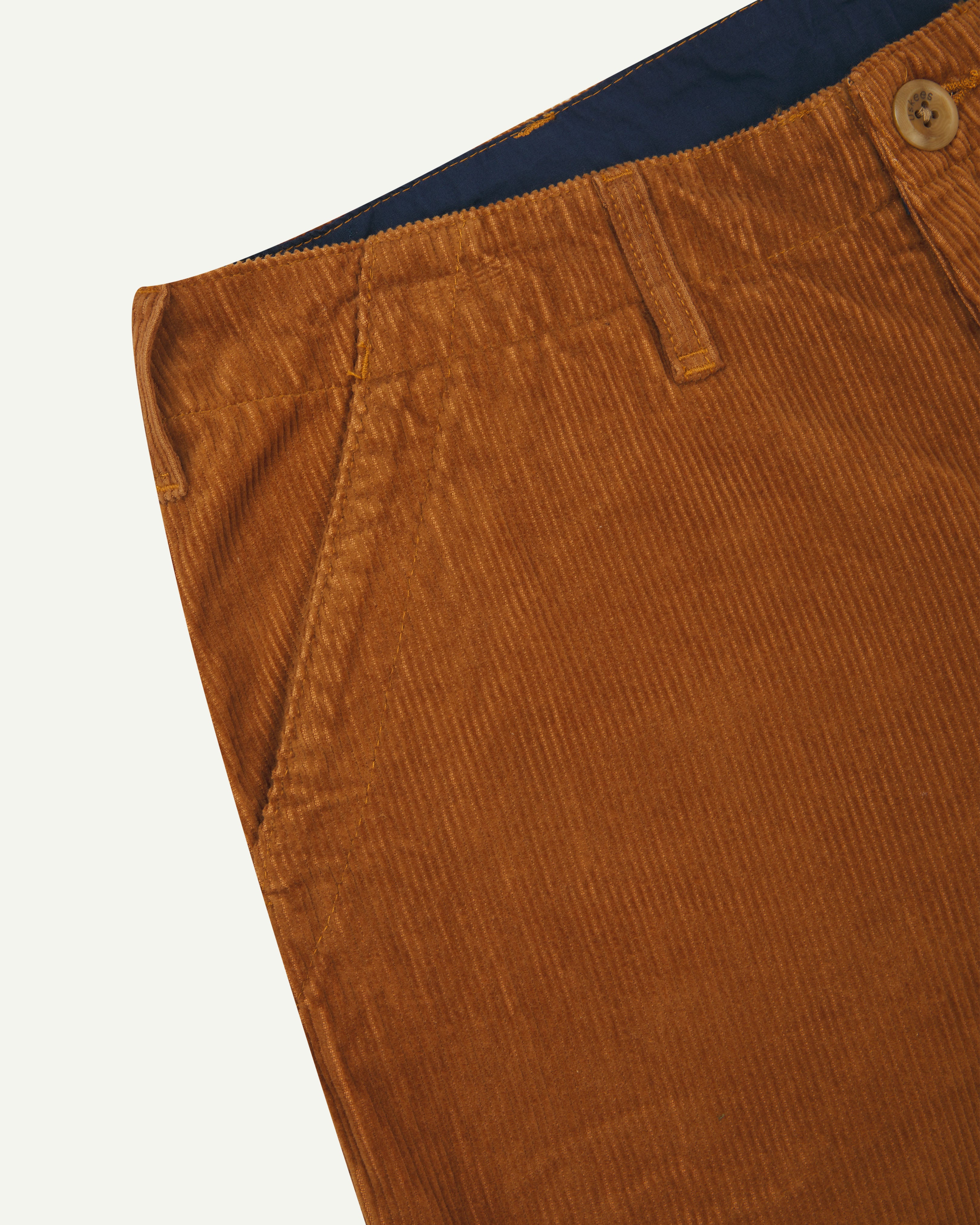 Close-up view of #5005 Uskees cord workwear pants in tan showing triple stitching.