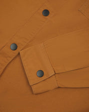  front flat shot of light brown uskees men's lightweight shirt with popper front and cuff fastening in close-up