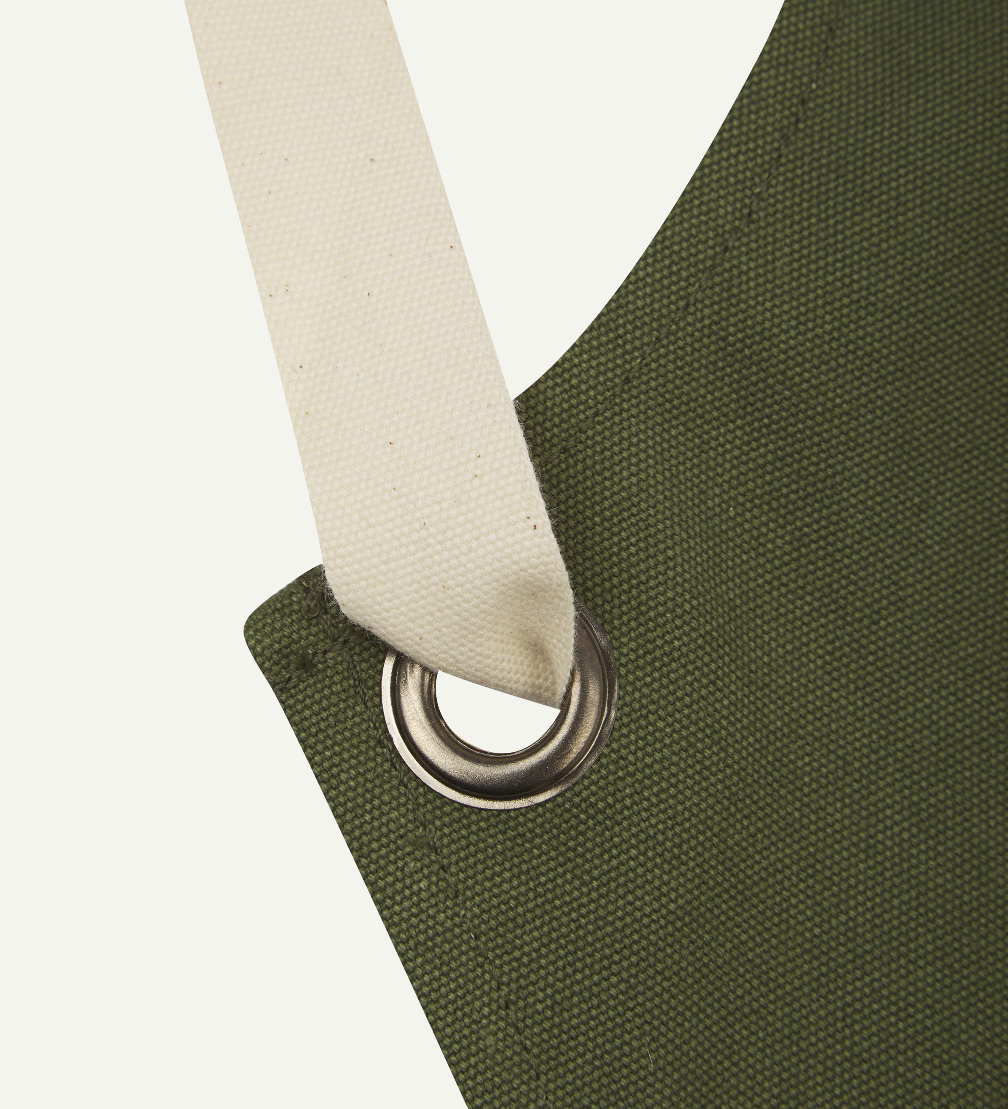 Close up shot of uskees unisex green canvas apron showing cream strap