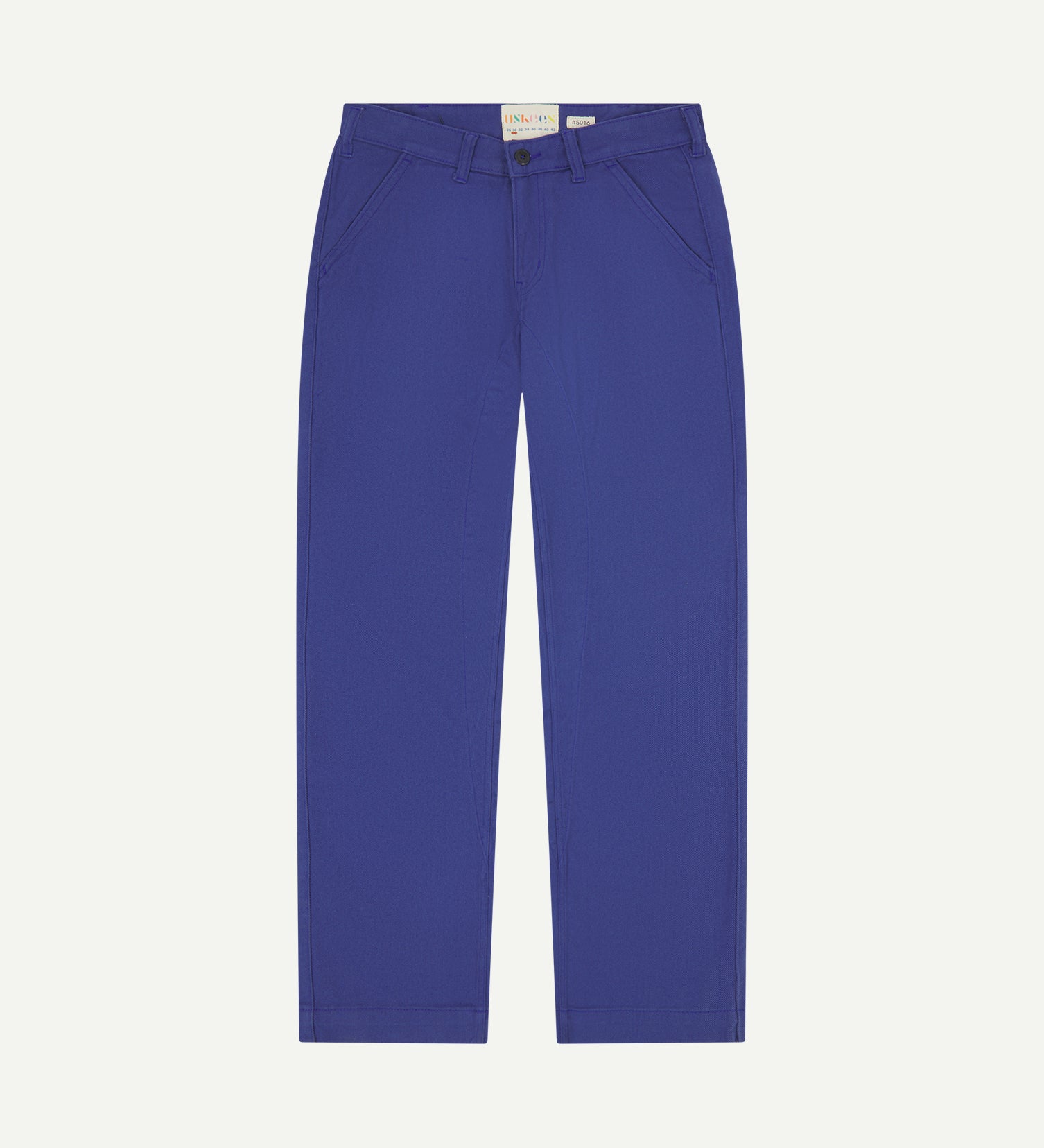 Front flat shot of Uskees cotton drill 'commuter' trousers for men in ultra blue showing brand label at waist