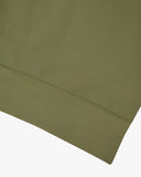 Close-up of an Uskees herb green sweatshirt showing the hem detail