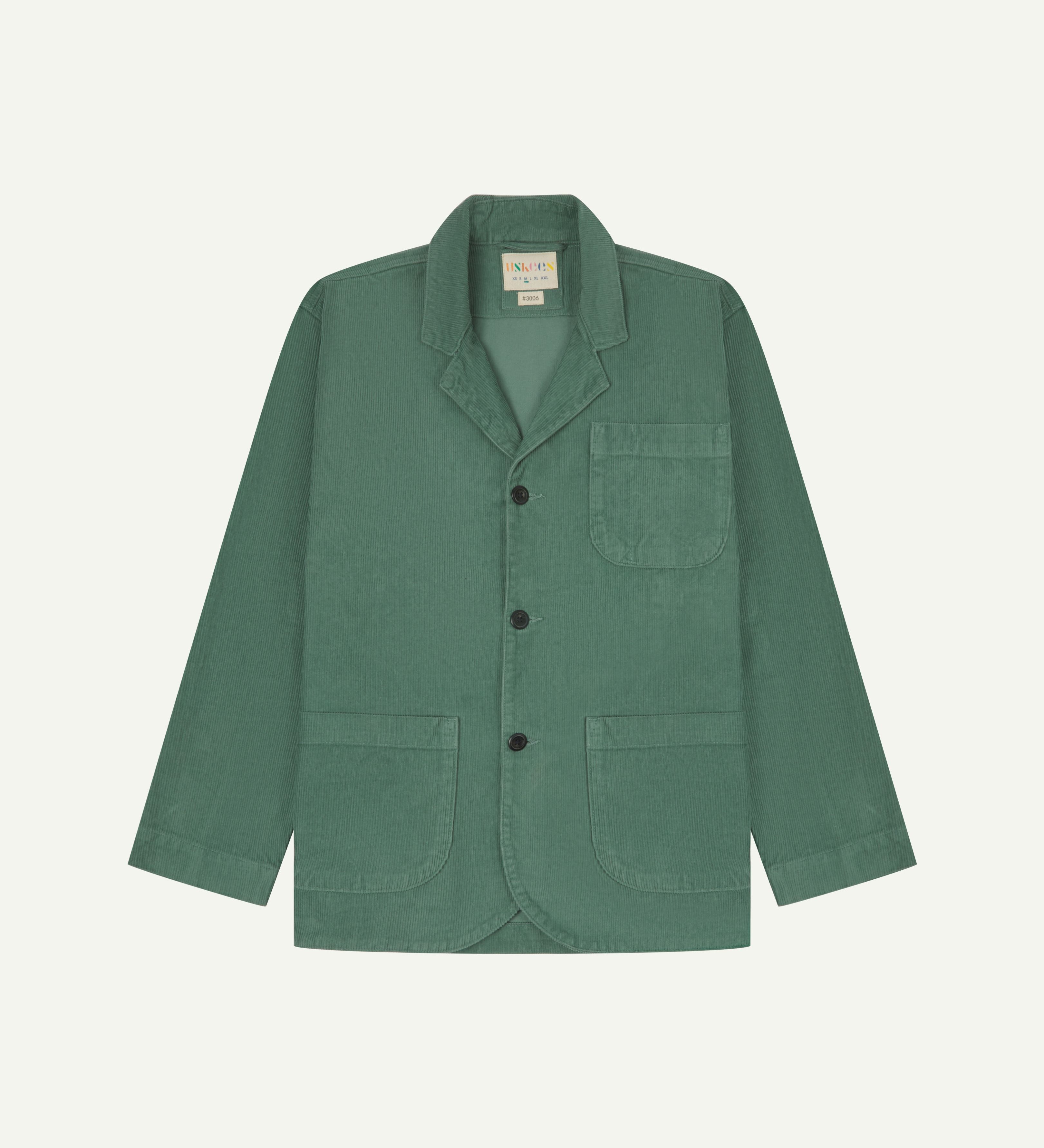 Front view of eucalyptus-green corduroy blazer with view of 3 patch pockets and Uskees branding label.