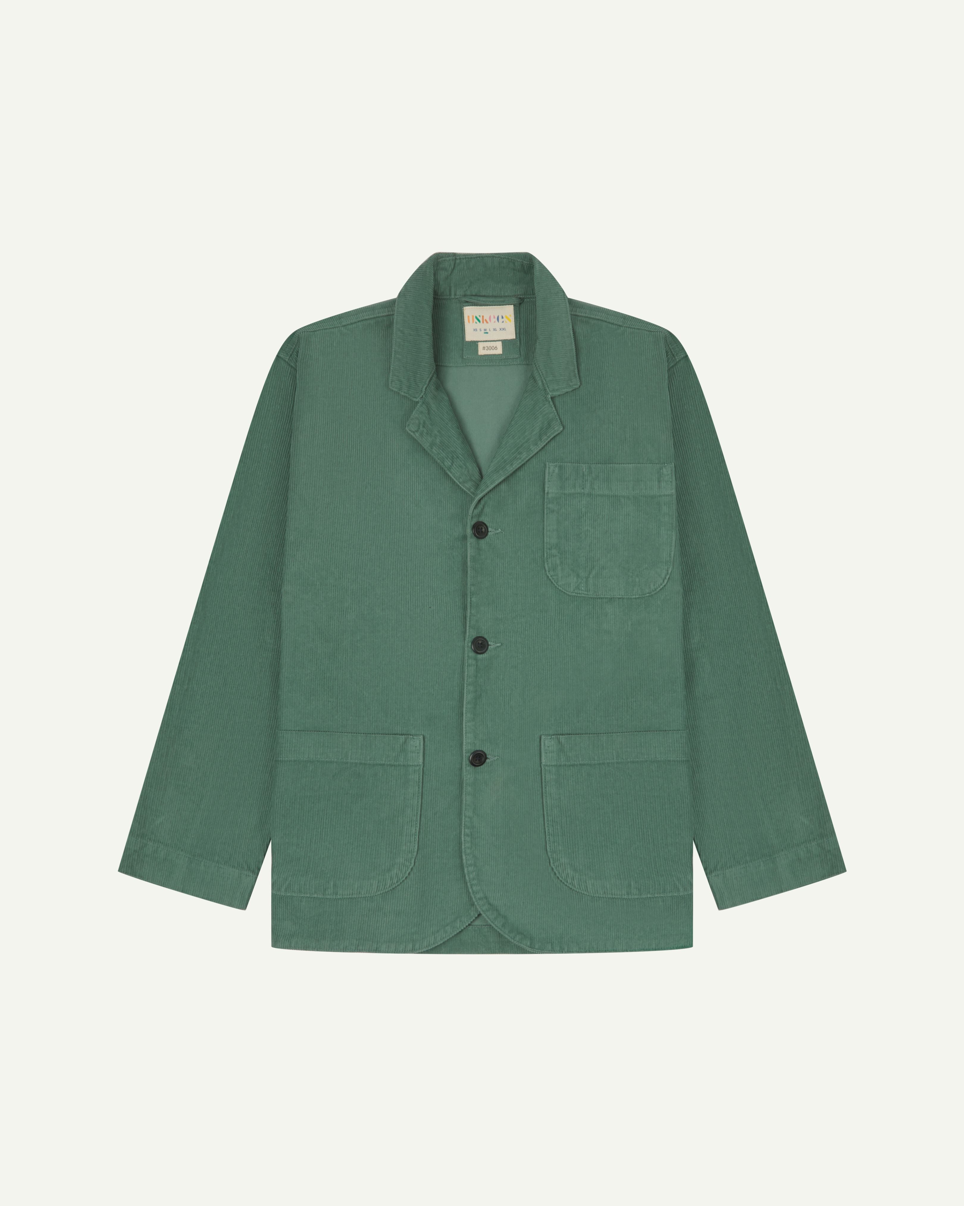 Front view of eucalyptus-green corduroy blazer with view of 3 patch pockets and Uskees branding label.