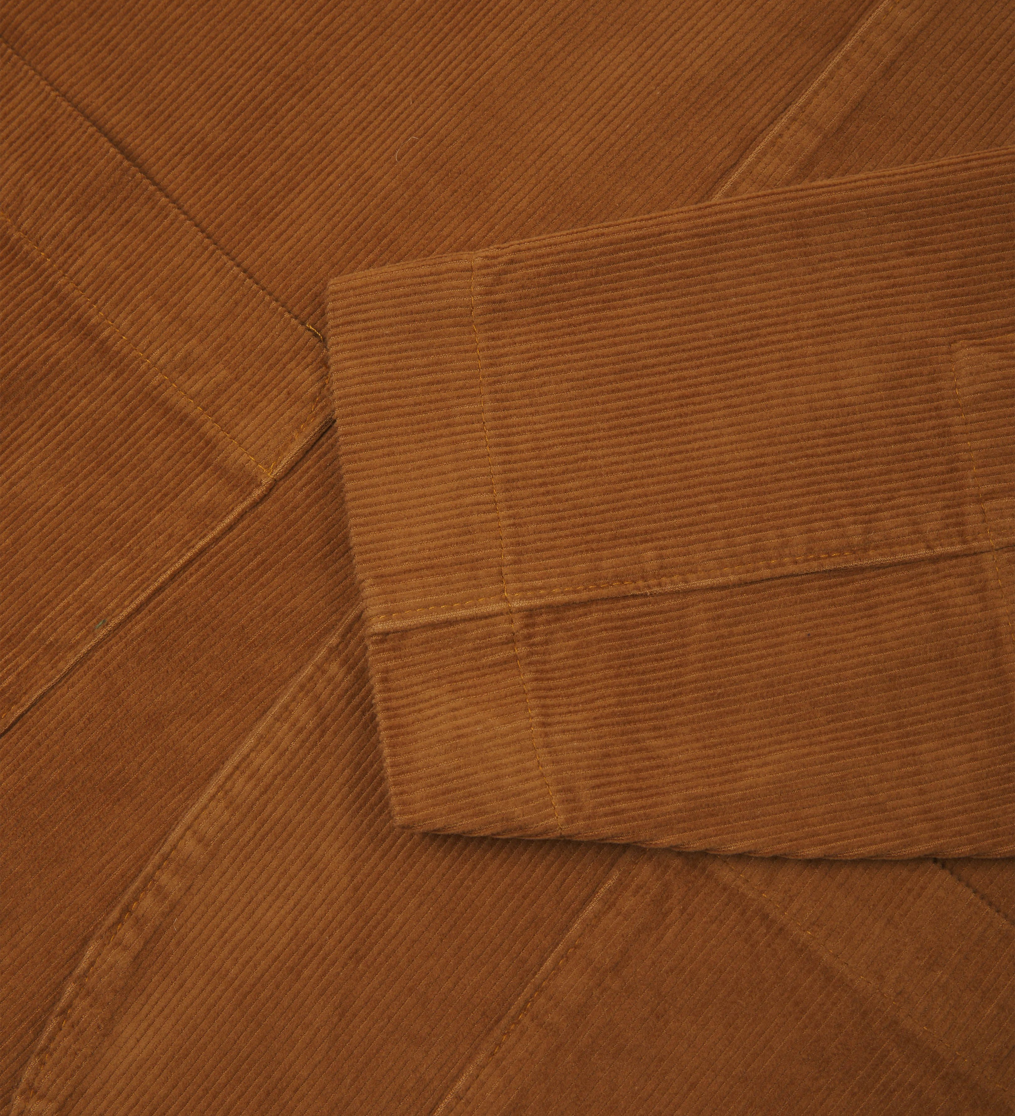Close-up view of tan corduroy blazer from Uskees showing cuff detail.