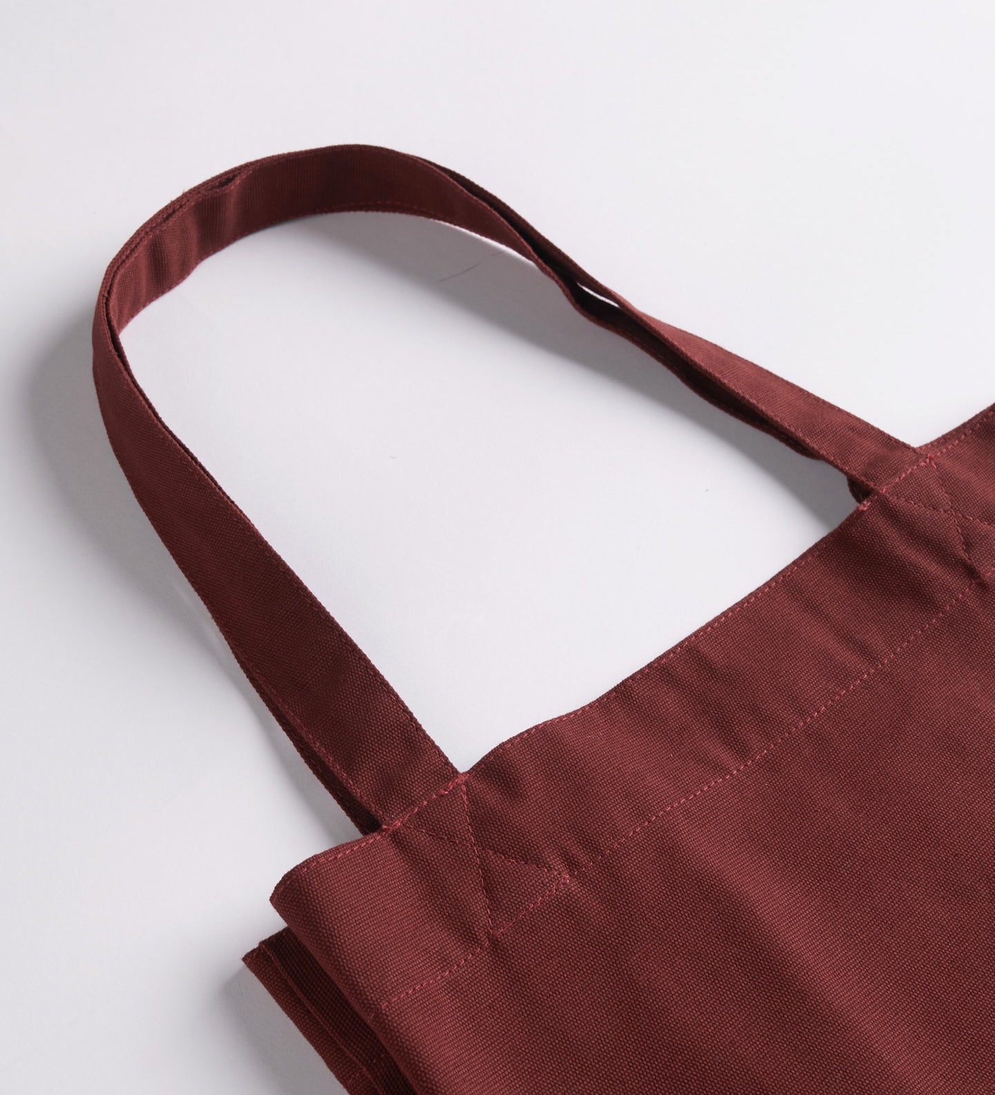 Close-up view of Uskees #4002 small tote bag in merlot-red with focus on the robust, twin carry handles.