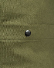 Focus on one of the several press studs to secure the external pockets of the moss-green Uskees #0402 bucket bag.