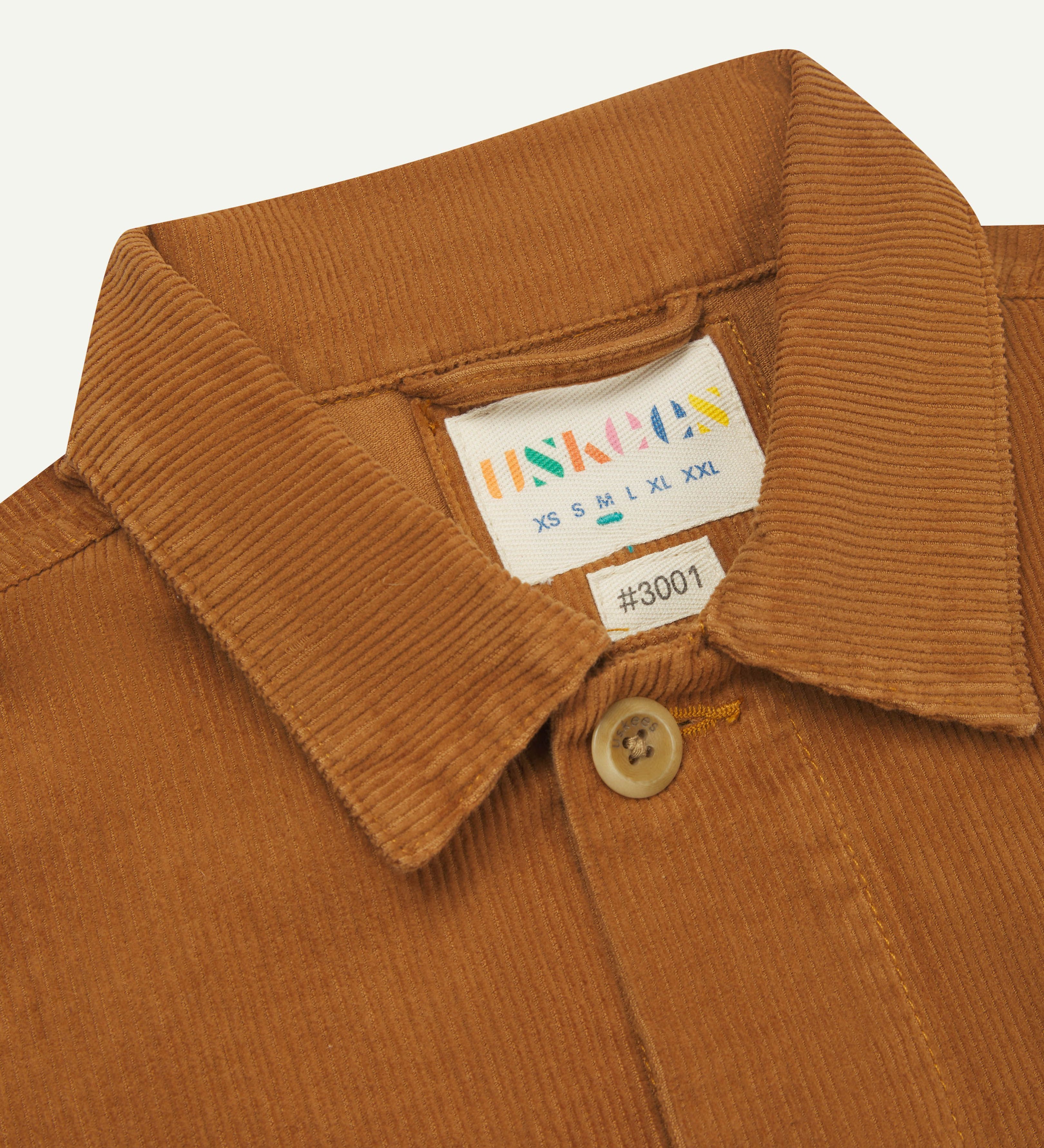  front close-up shot of Uskees tan corduroy #3001 over-shirt clearly showing collar and inner size label