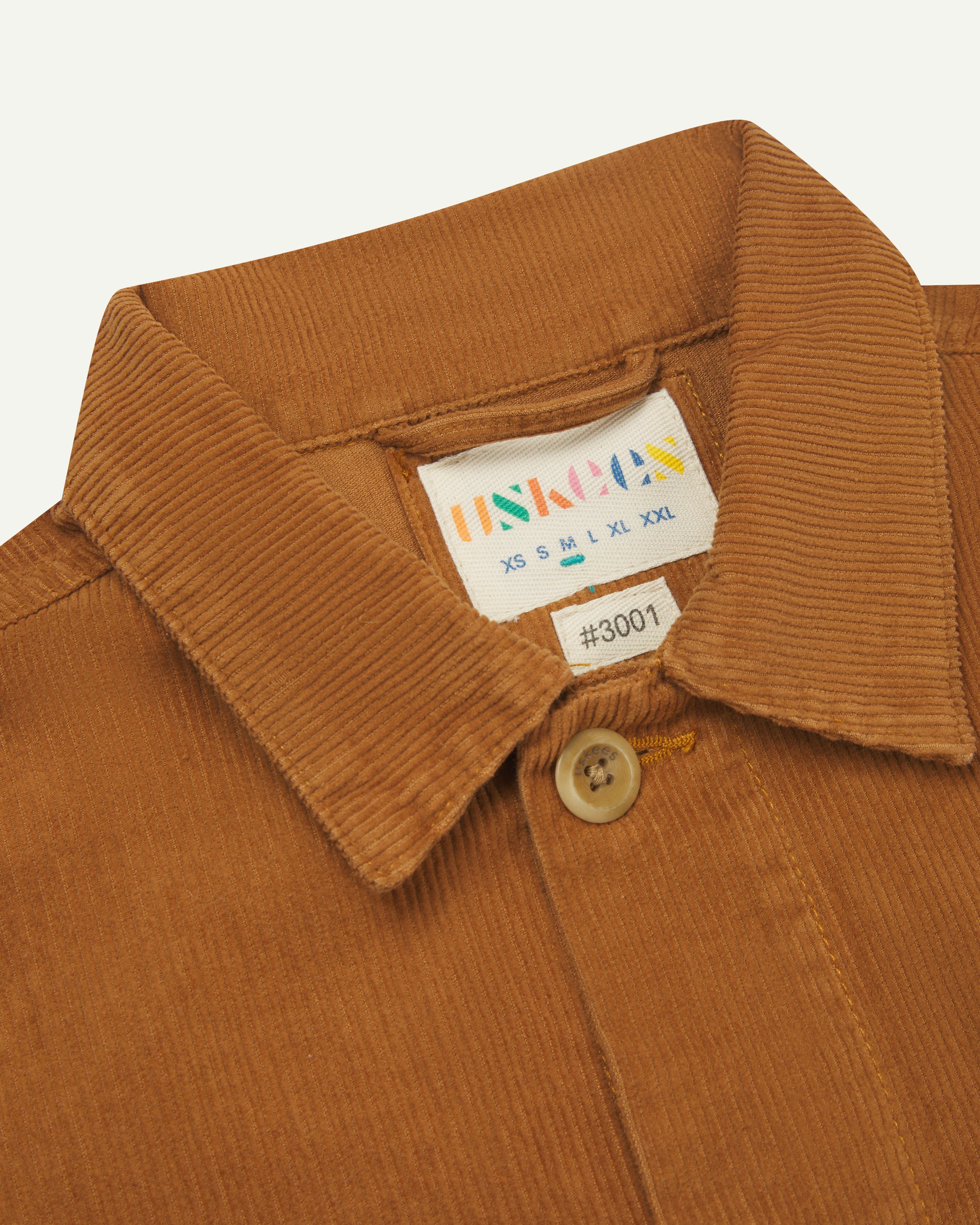  front close-up shot of Uskees tan corduroy #3001 over-shirt clearly showing collar and inner size label
