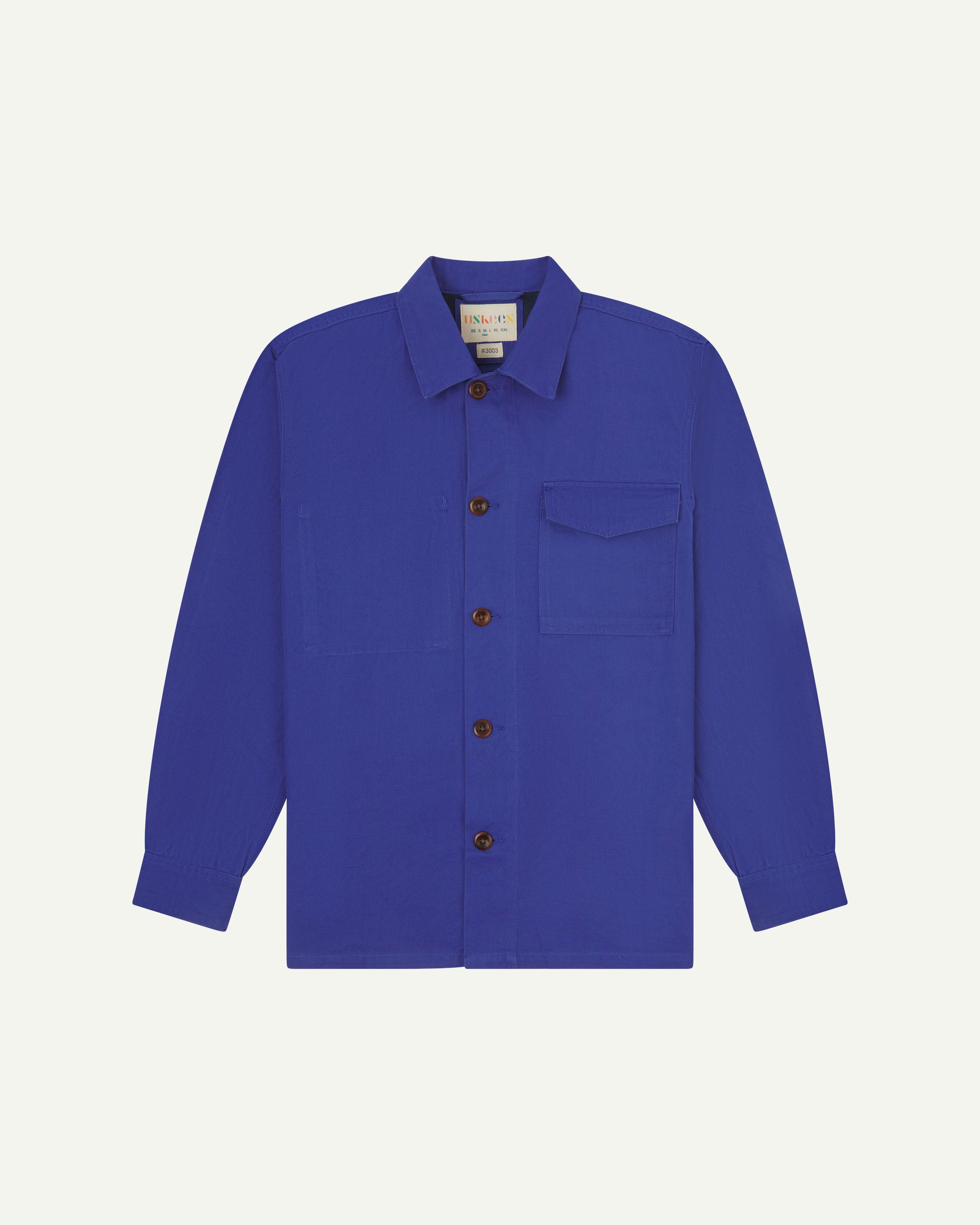 Front flat shot of ultra blue buttoned 3003 workshirt from Uskees. Showing chest pocket with flap and corozo buttons.