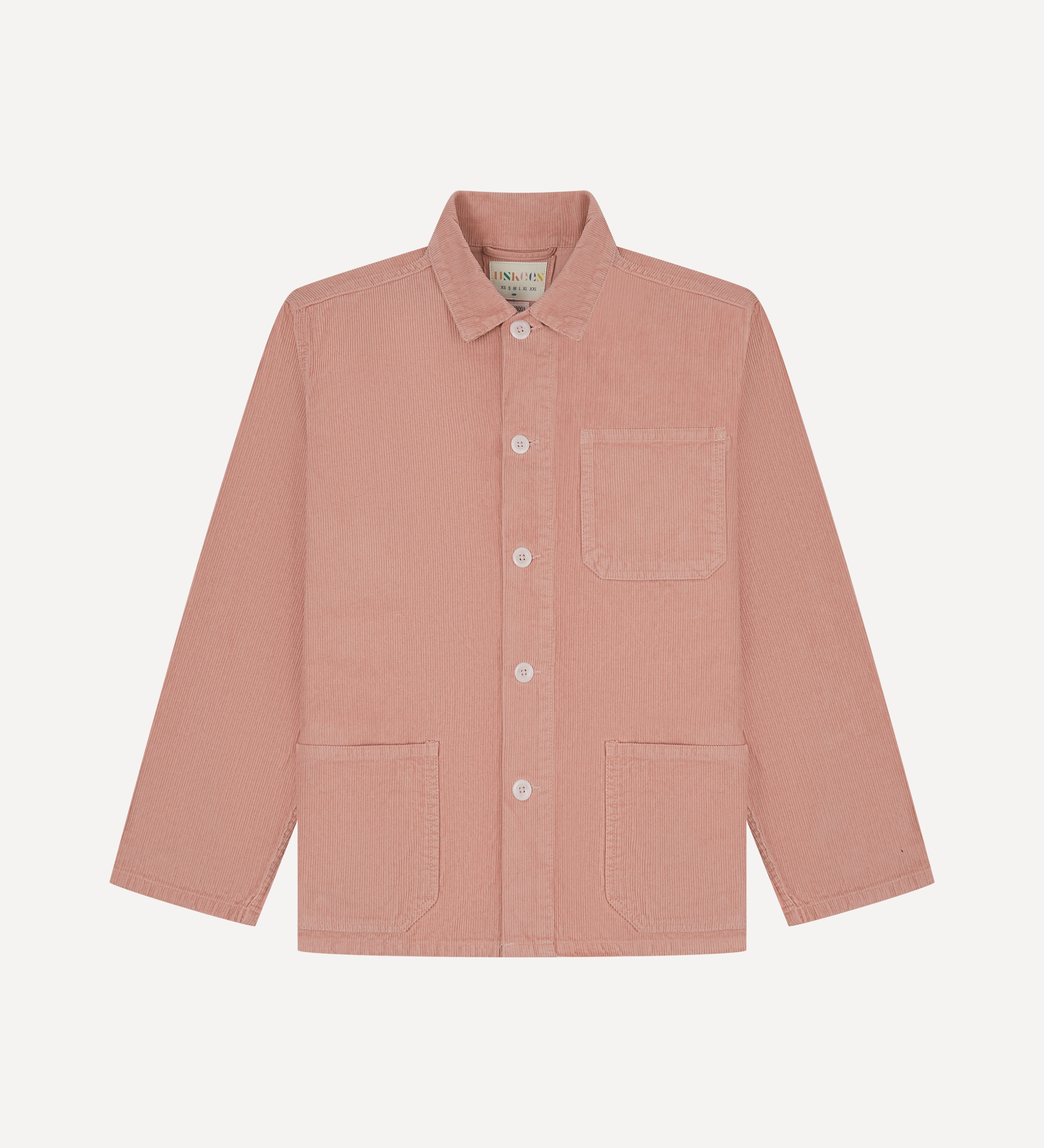 Front flat shot of pale pink, buttoned corduroy overshirt from Uskees. Clear view of corozo buttons, chest and hip pockets.