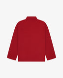Back view of berry red, buttoned organic cotton overshirt with view of reinforced elbow area and boxy silhouette.