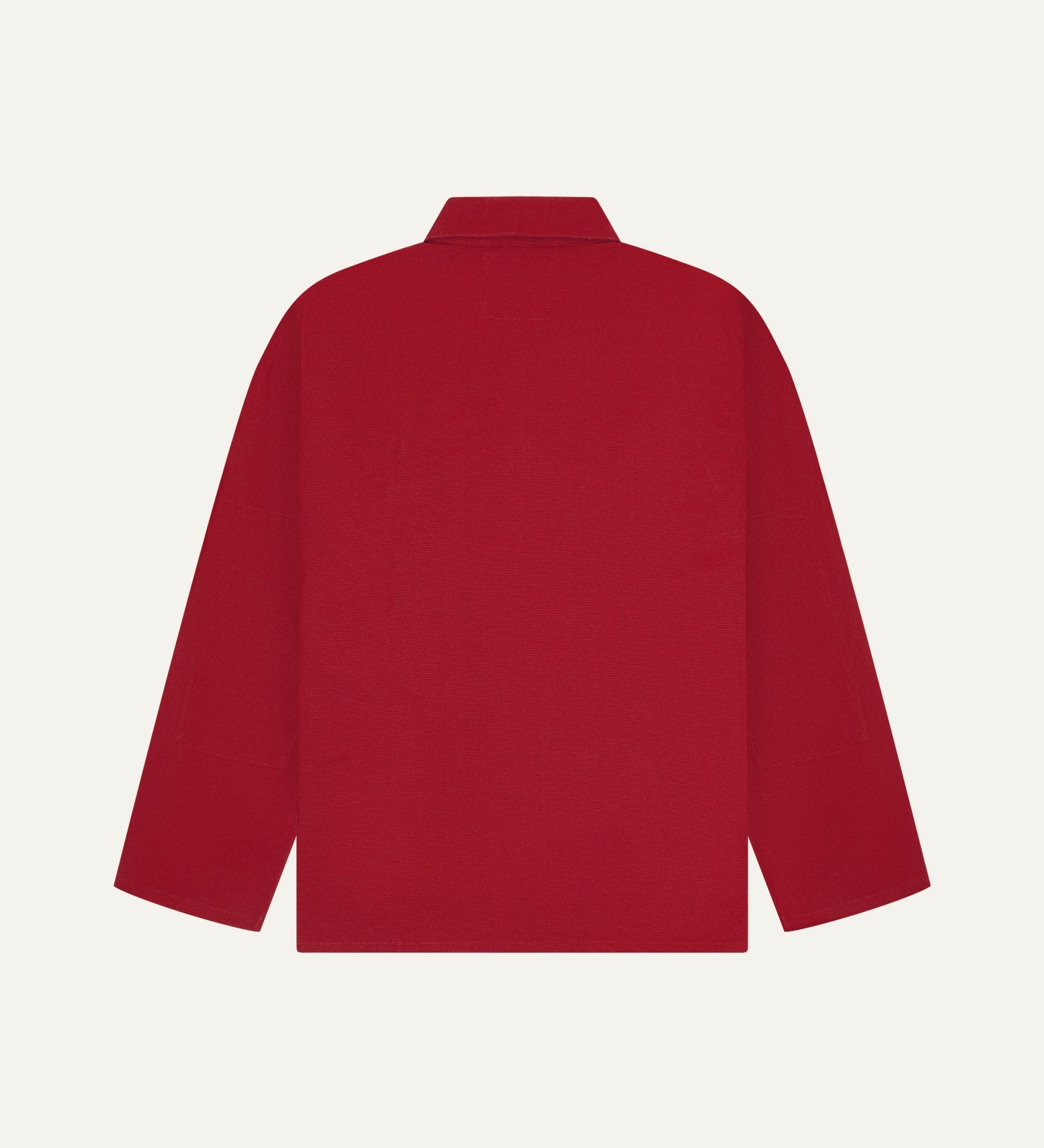 Back view of berry red, buttoned organic cotton overshirt with view of reinforced elbow area and boxy silhouette.